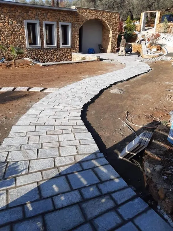 Curved grey Flagstone-Gehweg ochre clad villa — PelionStones.gr